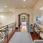 he grand foyer leads to the formal living room with 25+ ft. ceilings and a wraparound staircase. Gourmet kitchens feature Viking appliances, a built-in breakfast bar, and custom European cabinetry. Upstairs, the spacious primary suite features a fireplace and a luxurious ensuite bathroom with a steam shower, soaking tub, and two walk-in closets. A movie theater completes the main house.