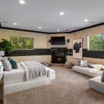 he grand foyer leads to the formal living room with 25+ ft. ceilings and a wraparound staircase. Gourmet kitchens feature Viking appliances, a built-in breakfast bar, and custom European cabinetry. Upstairs, the spacious primary suite features a fireplace and a luxurious ensuite bathroom with a steam shower, soaking tub, and two walk-in closets. A movie theater completes the main house.