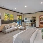 he grand foyer leads to the formal living room with 25+ ft. ceilings and a wraparound staircase. Gourmet kitchens feature Viking appliances, a built-in breakfast bar, and custom European cabinetry. Upstairs, the spacious primary suite features a fireplace and a luxurious ensuite bathroom with a steam shower, soaking tub, and two walk-in closets. A movie theater completes the main house.